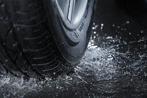 A car tyre with splashing water